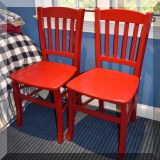 F62. Pair of red painted desk chairs. 